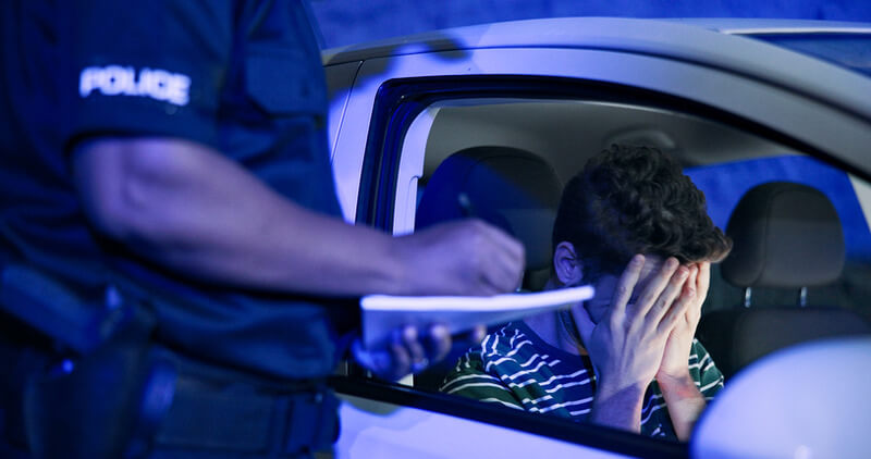 Man pulled over for DUI by police on a No Refusal Weekend holding his head in his hands